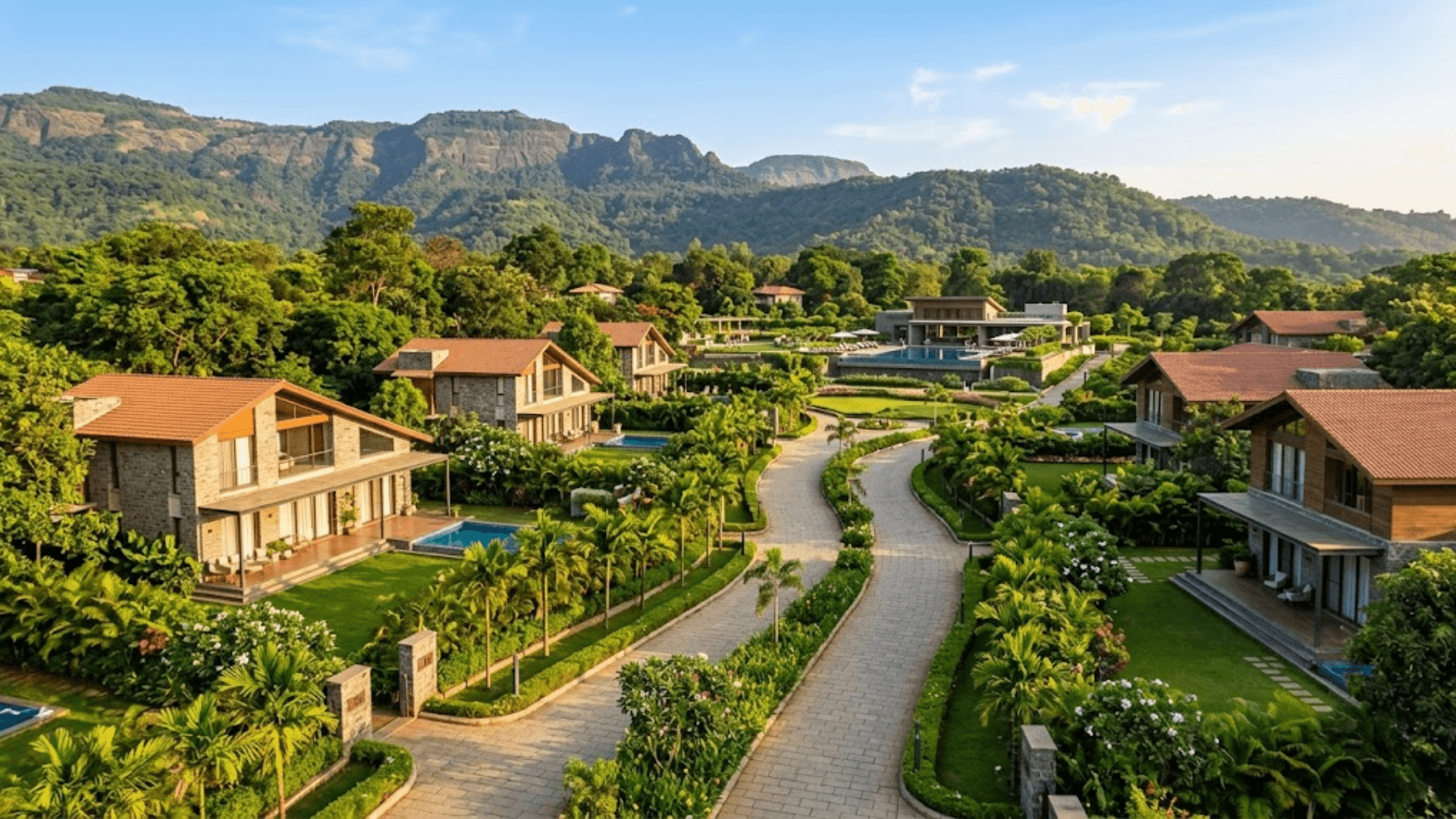 Luxury villas in a landscaped residential development surrounded by greenery and hills in Maharashtra.